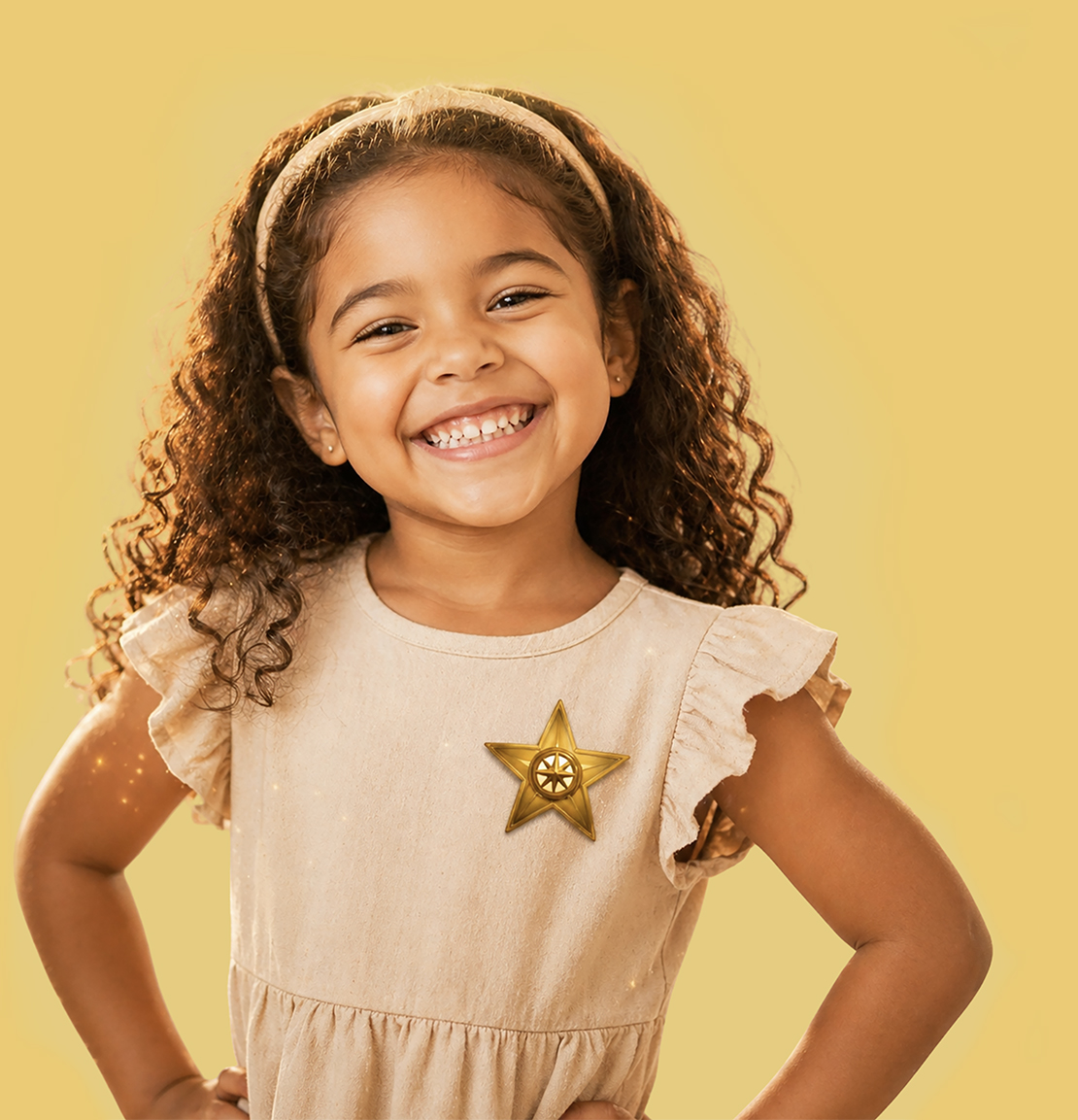 Smiling young girl standing confidently while wearing a bravery badge from The Garden of Growing Brave, representing confidence building and courage in children.