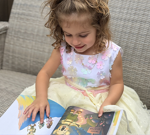Young child reading a calming story called The Garden of Growing Brave that supports nervous system regulation and helps manage big emotions through simple coping tools.
