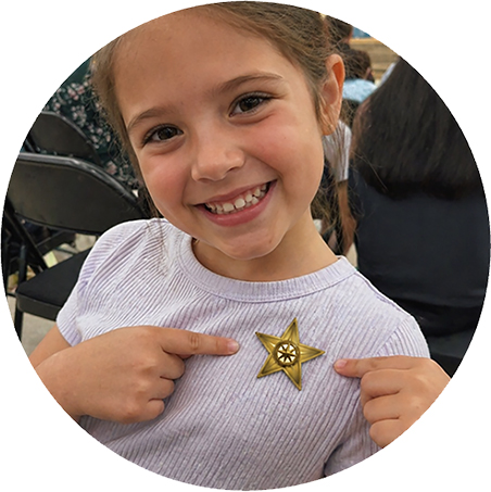 Author Jessica Borzino with child holding The Garden of Growing Brave, creating a meaningful keepsake after a storytime event.