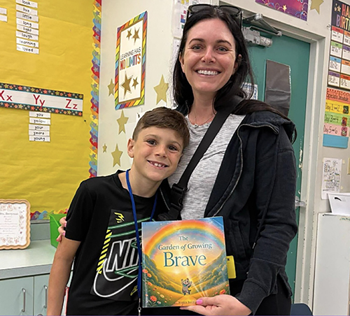 Teacher and student using a social emotional learning picture book called The Garden of Growing Brave in the classroom to build confidence, coping skills, and emotional awareness in elementary students.